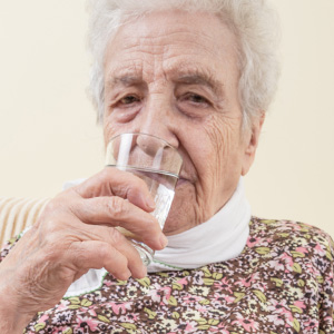 Skopek Orthodontics picture of an elderly drinking water