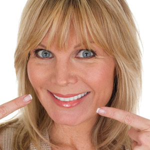 Portrait of a woman pointing out her beautiful smile Skopek Orthodontics